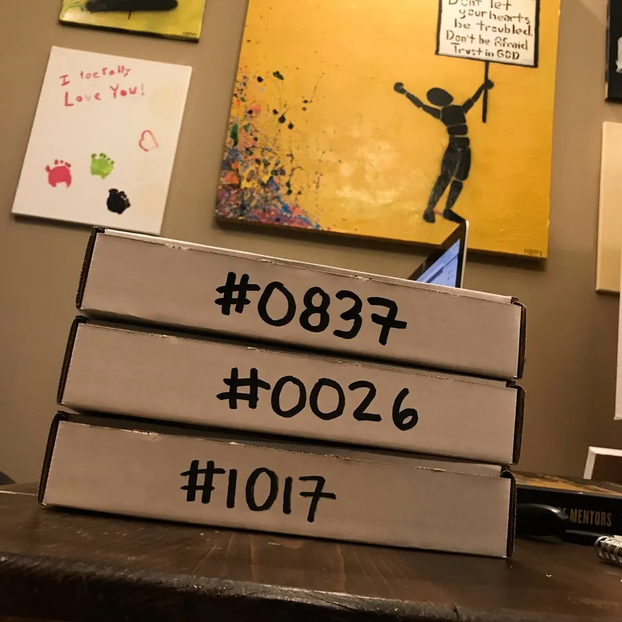 Three mailer boxes with #0837, #0026 and #1017 written in marker